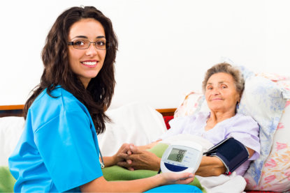 Staff using Sphygmomanometer with patient